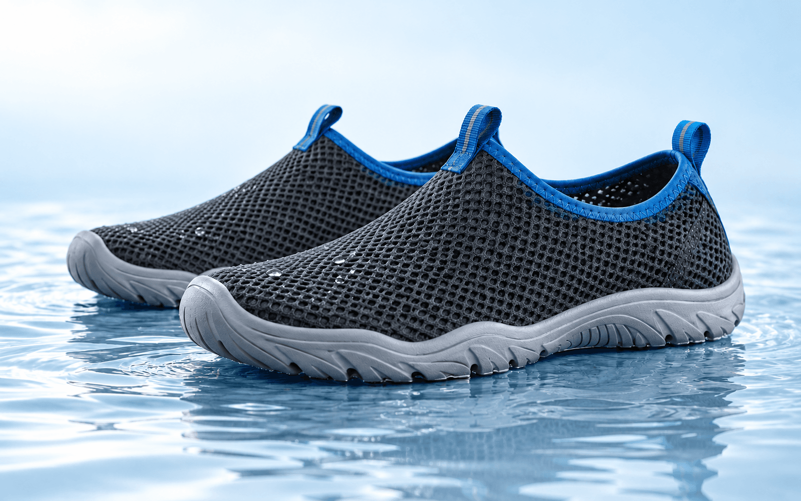 Concept illustration of mesh water shoes on a shallow reflective surface against a blue-white background.
